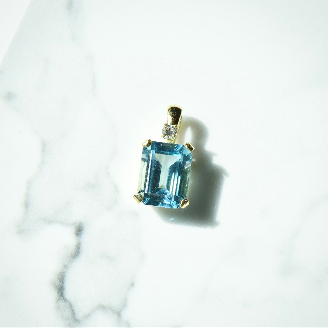 The Blue Topaz Charm